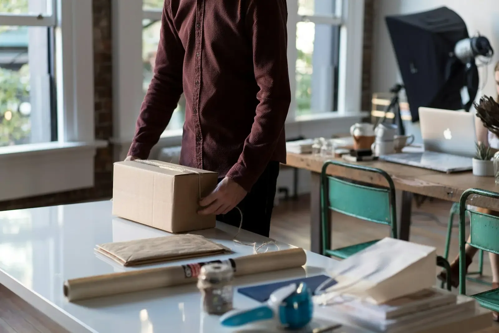 Hands packing a box